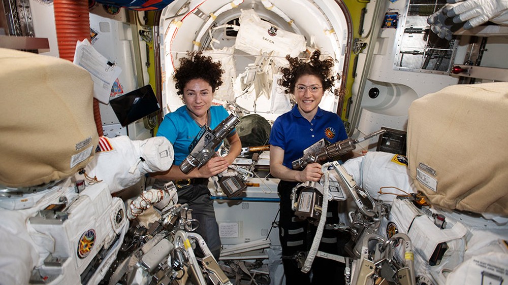 As astronautas da Nasa Jessica Meir (à esquerda) e Christina Koch dentro da câmara Quest, preparando os trajes espaciais e as ferramentas dos EUA que usarão na primeira caminhada 100% feminina no espa