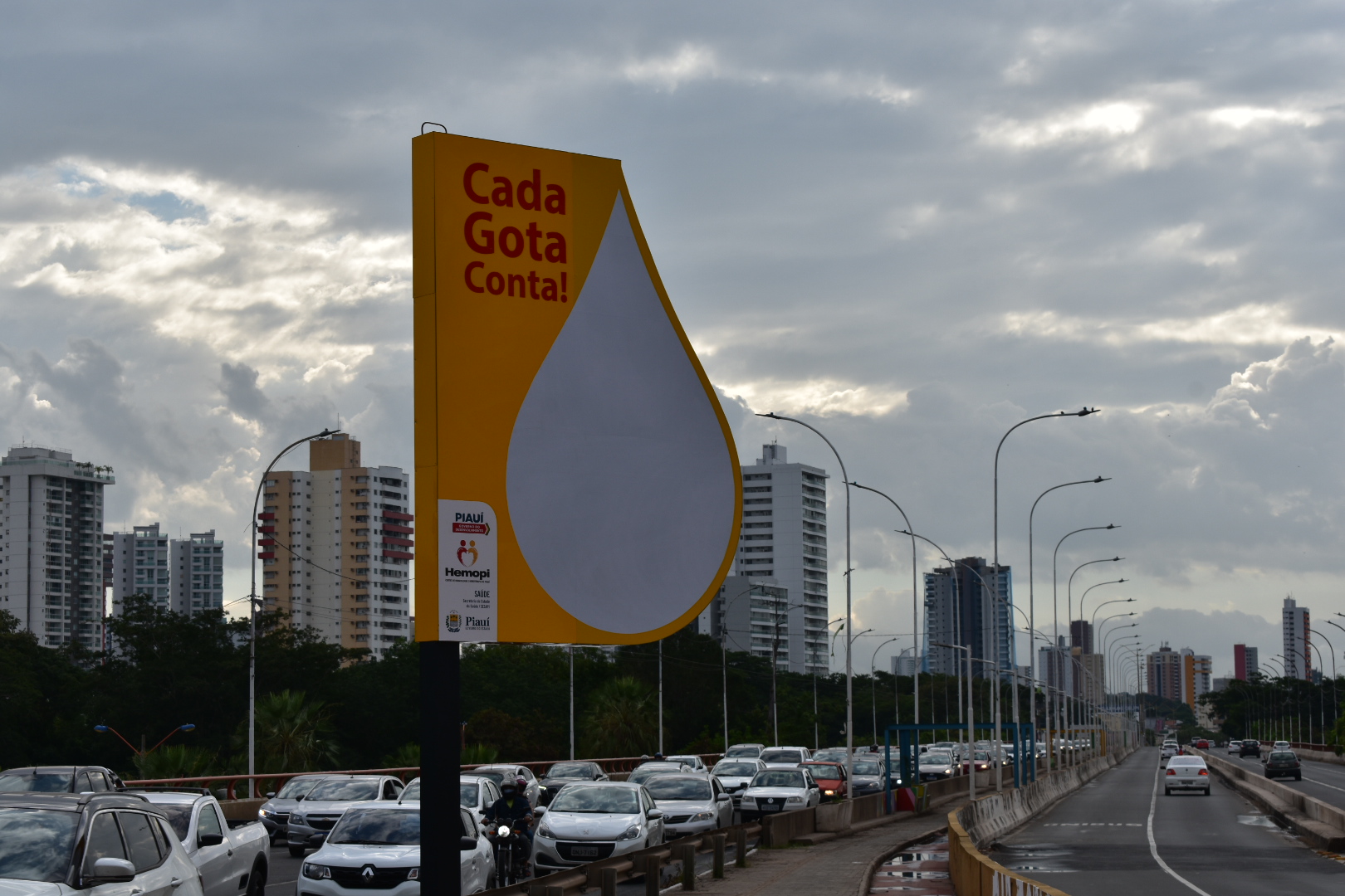 Placa instalada na ponte Juscelino Kubitschek, a cada mil bolsas coletadas, a gota vai sendo preenchida de vermelho